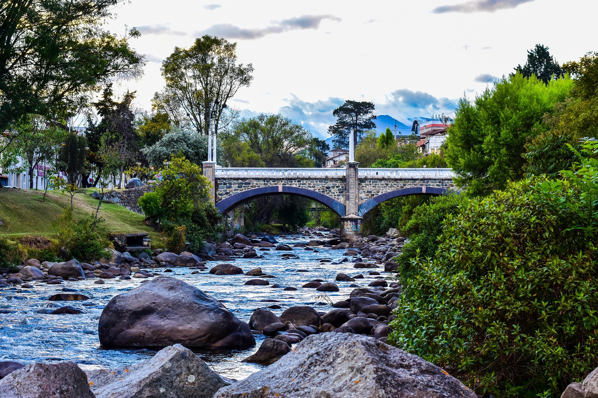 Tomebamba River flowing under a historic stone bridge in Cuenca