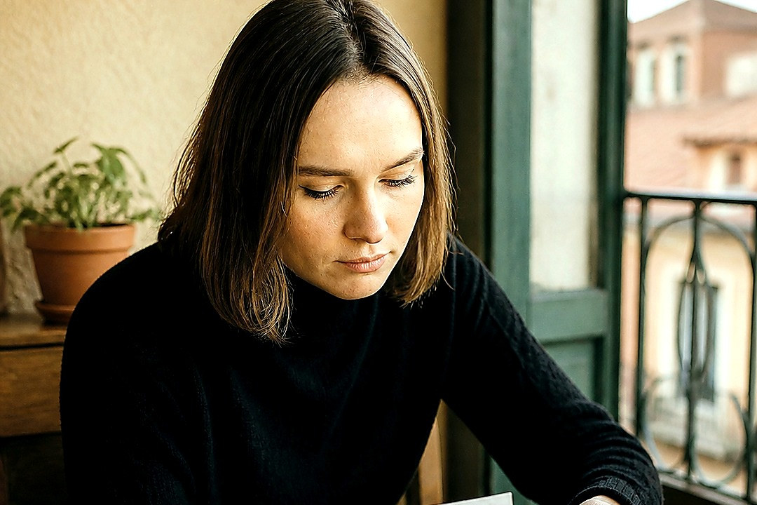 Woman reviewing receipts and household expenses at a table.